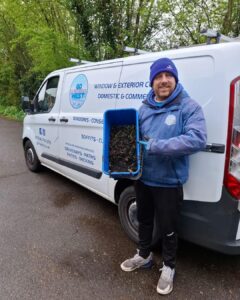 holding box of rubbish from gutter